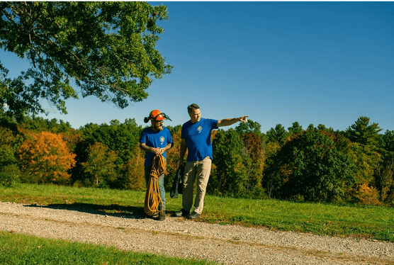 men standing in field pointing, b&r tree service